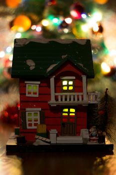 The photograph shows a house with a Christmas tree