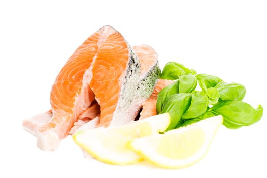 Salmon cuts with basil and lemon isolated on white