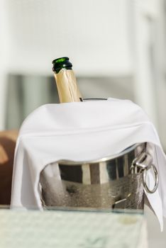 Opened bottle of Champagne in ice bucket
