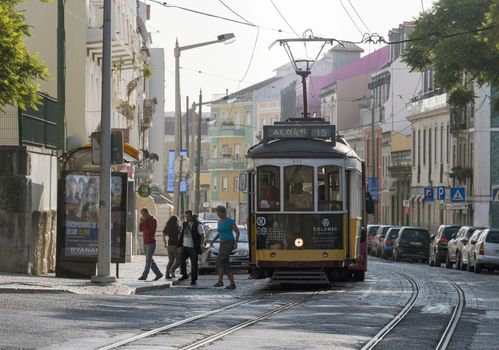 LISBON, PORTUGAL - SEPTEMBER 26: Unidentified people getting of the Yellow tram  goes by the street of Lisbon city center on September 26, 2015. Lisbon is a capital and must famous city of Portugal