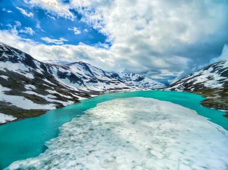 Frozen lake in norwegian mountains on Gamle Strynefjellsvegen mountain pass