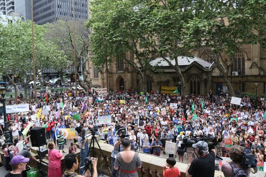 AUSTRALIA, Sydney: #StandUp4Refugees protesters carry signs as they march to Belmore Park after a rally at Sydney Town Hall on October 11, 2015; thousands demonstrate across Australia to support asylum seekers and oppose mandatory detention.