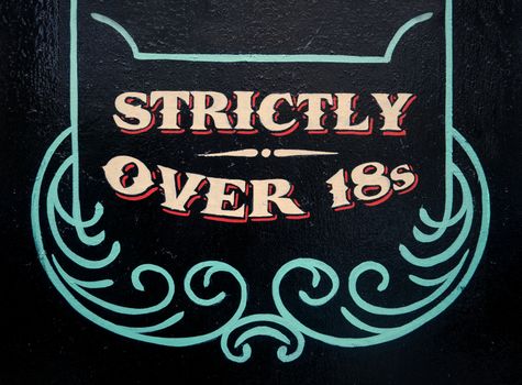 A Sign On A Wall Saying Strickly Over 18s