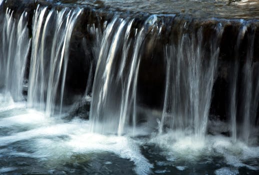 Poland.Park in Warsaw.Autumn.October.Small waterfall in the park.Horizontal , sideways.