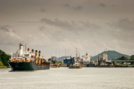 Several ships lined up to enter the locks of the Panama Canal.