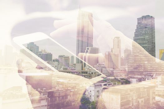 Double exposure image of people with smart phone and cityscape background,Business technology concept.