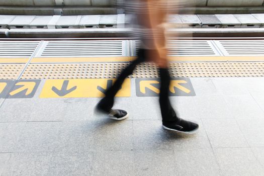 urbanism,people and arrow sign on skytrain station floor