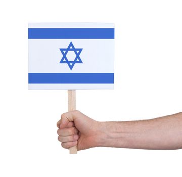 Hand holding small card, isolated on white - Flag of Israel