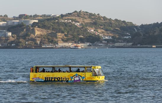LISBON, PORTUGAL - SEPTEMBER 26, 2015: Sightseeing amphibian bus HIPPOtrip is crossing the river Taag in Lissabon on September 26, 2015. Lisbon is a capital and must famous city of Portugal