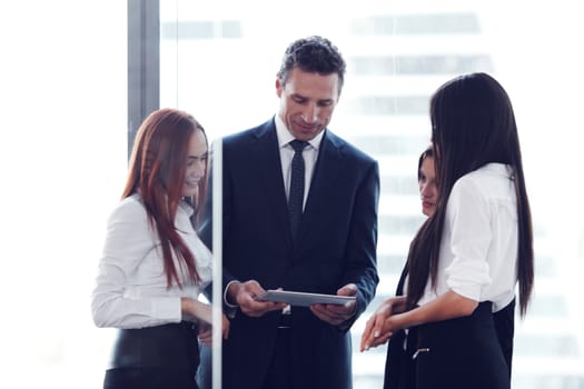 Group of business people using tablet in office