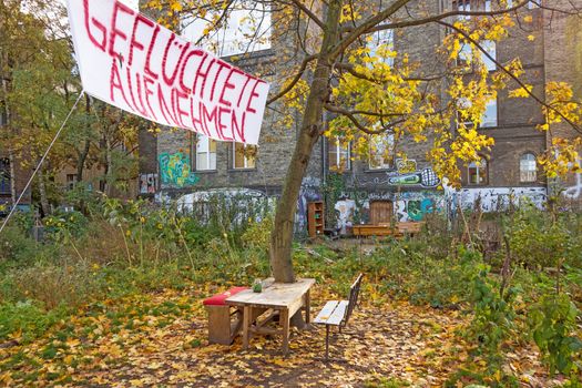 Berlin, Germany - October 26, 2013: Banner inscribed with "Admit Refugees" (Gefluechtete aufnehmen) - in a less wealthier neighborhood of Berlin, Germany.