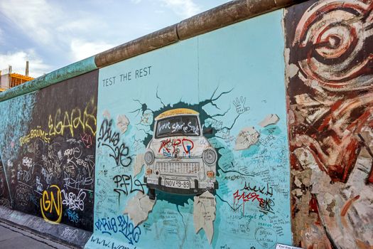Berlin, Germany - October 26, 2013: the murial titled "Test the Rest" by Birgit Kinder on a remnant of the Berlin Wall, East Side Gallery, Berlin.