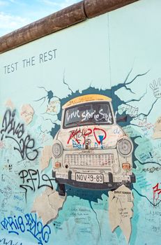 Berlin, Germany - October 26, 2013: the murial titled "Test the Rest" by Birgit Kinder on a remnant of the Berlin Wall, East Side Gallery, Berlin.