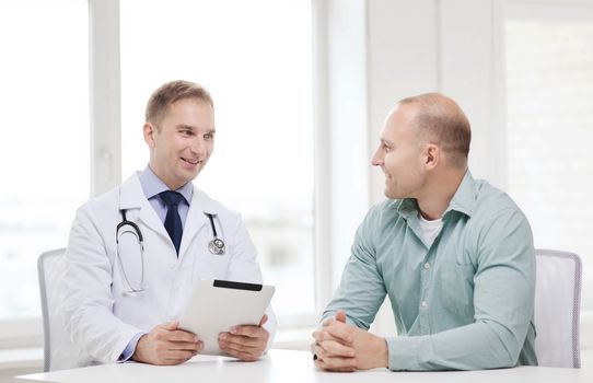 healthcare, technology and medicine concept - smiling doctor with tablet pc computer and patient in hospital