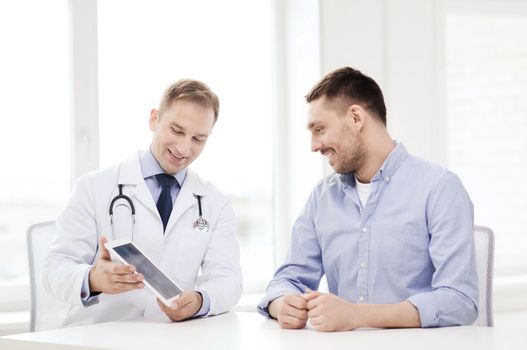 healthcare, technology and medicine concept - smiling doctor with tablet pc computer and patient in hospital