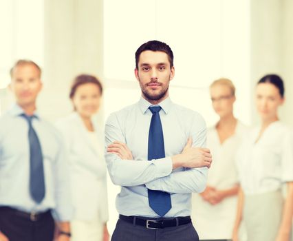 business and office concept - handsome businessman with crossed arms