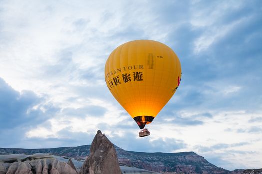 Yellow hot air balloon flying
