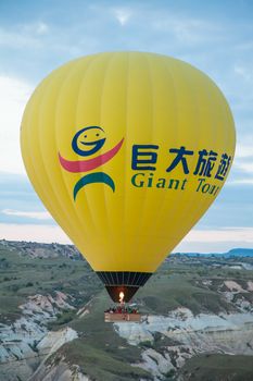 Yellow hot air balloon flying