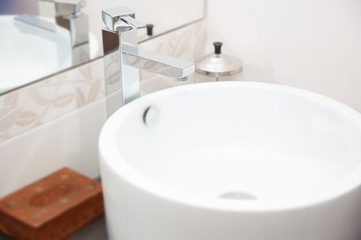 Sink and water tap. Horizontal close-up photo