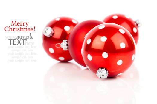 red polka dot Christmas bauble, isolated over white