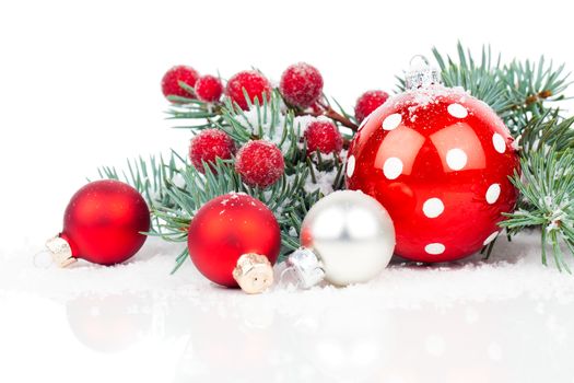 Christmas balls and fir branches with decorations isolated over white