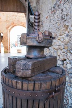 old wooden manual press used to press the grapes and make wine in Italy