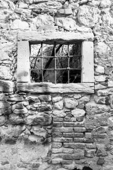 old window grille of a ruined castle in Italy