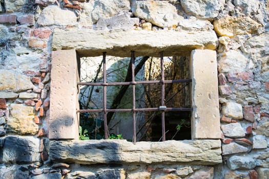 old window grille of a ruined castle in Italy