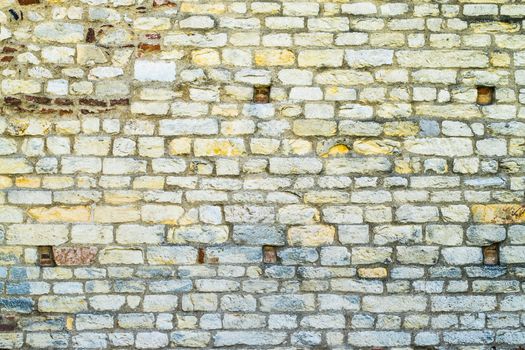 ancient colored wall made of stone and brick