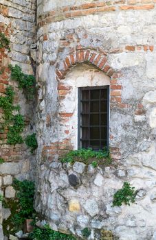 old window grille of a ruined castle in Italy