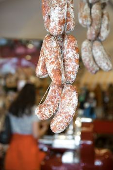 sausages hanging to mature in an Italian butcher.