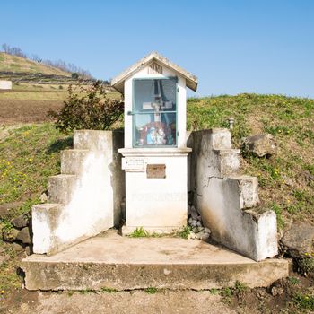 Italian traditional votive temple in the countryside dedicated to the holy family to propitiate the harvest