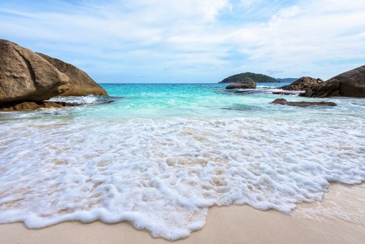 Beautiful nature of blue sea sand and white waves on small beach near the rocks during summer at Koh Miang island in Mu Ko Similan National Park, Phang Nga province, Thailand