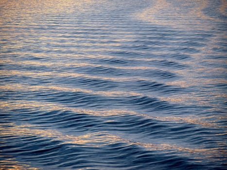 Sea ocean surface blue and golden ripples small waves