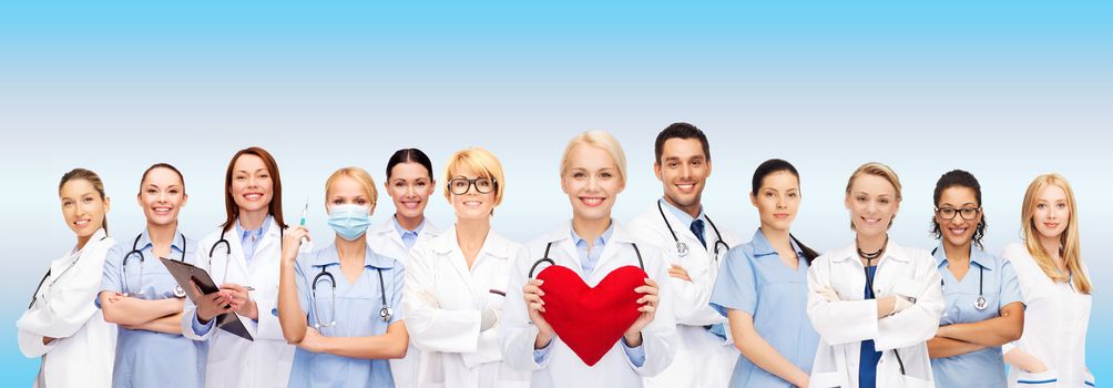 healthcare and medicine concept - smiling doctors and nurses with red heart