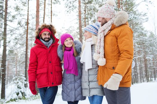 love, relationship, season, friendship and people concept - group of smiling men and women talking in winter forest