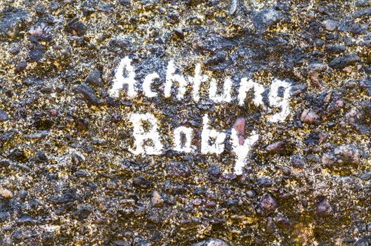 Old concrete wall with inscription in white color, Achtung Baby.