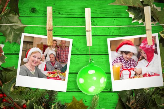 Hanging christmas photos against green wooden planks background