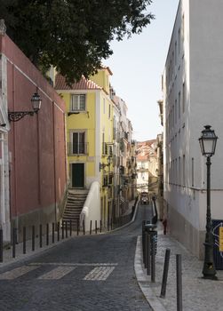 typical lisbon street with tuktuk taxi