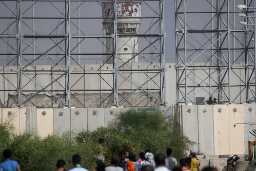 PALESTINE, Gaza Strip: A group of Palestinian protesters gathers near the Erez border crossing between Israel and the Gaza Strip on October 13, 2015.As a wave of stabbings hit Jerusalem, violent protests flared up in the West Bank. The unrest has lead to warnings that a full-scale Palestinian uprising, or Intifada, could erupt. The unrest has also spread to the Gaza Strip, with fighting along the border in recent days leaving nine Palestinians dead. 