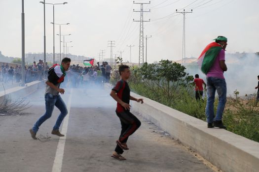 PALESTINE, Gaza Strip: A group of Palestinian protesters gathers near the Erez border crossing between Israel and the Gaza Strip on October 13, 2015.As a wave of stabbings hit Jerusalem, violent protests flared up in the West Bank. The unrest has lead to warnings that a full-scale Palestinian uprising, or Intifada, could erupt. The unrest has also spread to the Gaza Strip, with fighting along the border in recent days leaving nine Palestinians dead. 