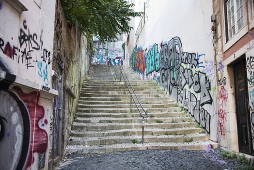 LISBON, PORTUGAL - SEPTEMBER 26 2015: Graffit on walls near staircase in Lisbon on September 26, Lisbon is the capital of Portugal