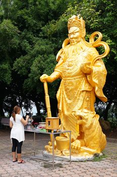 Hat Yai, Thailand -  13 Sept, 15 :Golden buddha was blessing people for safety and smoothly. Goddess of  Compassion &amp; Mercy is located on top of a hill at Hat Yai Municipal Park. It is about 1000 steps to the hilltop where there is 360 degree panoramic view of Hat Yai City and Songkhla.