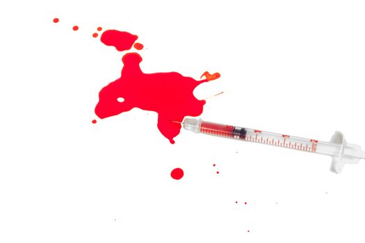 High Angle View of Syringe Needle Squirting Red Liquid or Blood onto White Background in Studio Still Life - Concept Image