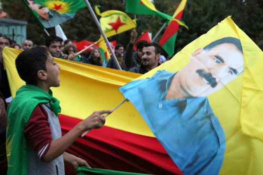 ITALY, Turin: A boy holds an image of Turkish President Recep Tayyip Erdogan as thousands march through Turin, Italy on October 13, 2015. They rally to show solidarity with the people of Turkey, after the weekend's bombings in Ankara that left at least 97 dead. Demonstrators protest against the Turkish government, blaming the administration for the attack. Some Kurdish and leftist activists have asserted that these bombings were perpetrated in part by Turkey's governing AKP administration, intended as a blow to the pro-Kurdish HDP opposition ahead of the snap parliamentary elections in November. 