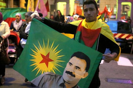 ITALY, Turin: A boy holds an image of Turkish President Recep Tayyip Erdogan as thousands march through Turin, Italy on October 13, 2015. They rally to show solidarity with the people of Turkey, after the weekend's bombings in Ankara that left at least 97 dead. Demonstrators protest against the Turkish government, blaming the administration for the attack. Some Kurdish and leftist activists have asserted that these bombings were perpetrated in part by Turkey's governing AKP administration, intended as a blow to the pro-Kurdish HDP opposition ahead of the snap parliamentary elections in November. 
