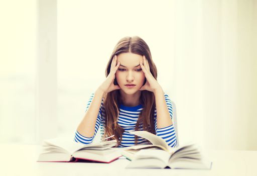 education and home concept - stressed student girl with books