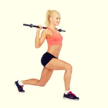 fitness, sport and exercise concept - smiling sporty woman with barbell doing split squat or lunge