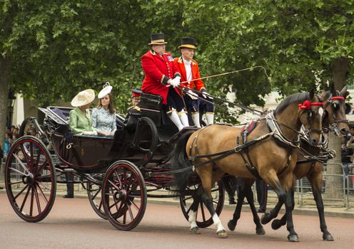 London, England - June 13, 2015: Kate, Duchess of Cambridge, in an open carriage with Camilla, Duchess of Cornwall, and Prince Harry for trooping the colour 2015.