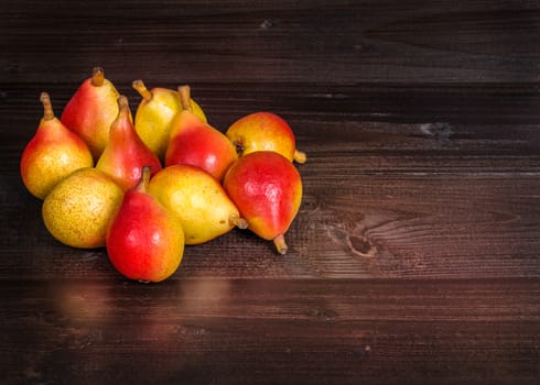 In the picture a set of pears  "Angelica" Typical Italian, placed on wooden boards brown and empty space on the right.